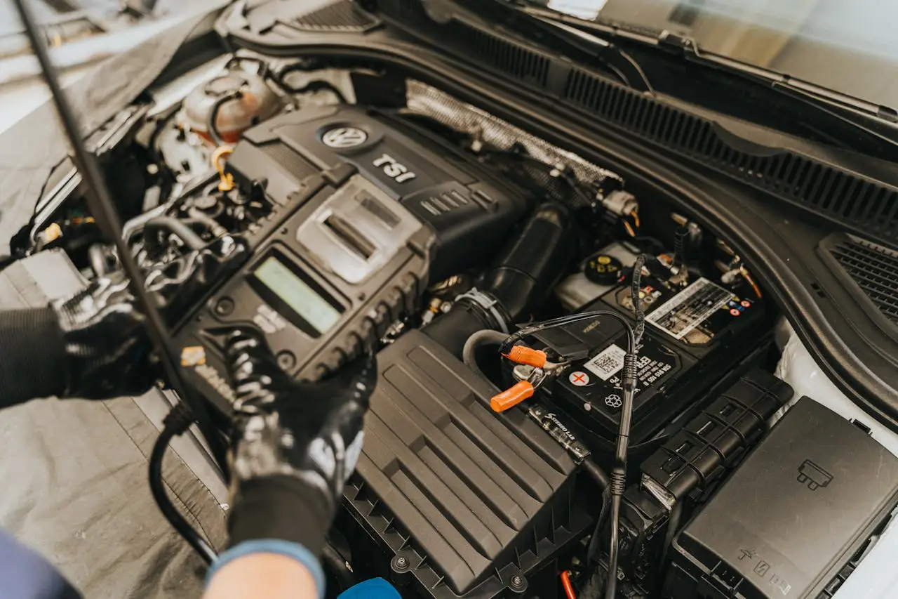 about-us Close-up view of a mechanic diagnosing a Volkswagen engine with specialized equipment.